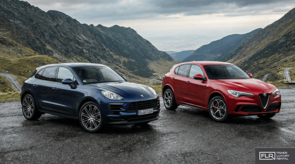 Porsche Macan and Alfa Romeo Stelvio Quadrifoglio on a mountain road overlook.