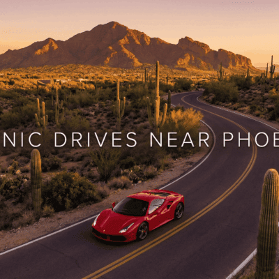 Ferrari driving through Phoenix desert landscape near Camelback Mountain.